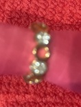 Adjustable Gold Ring, white crystals, band perforated with holes.  Size 6.